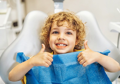 A little boy smiling after a dental checkup