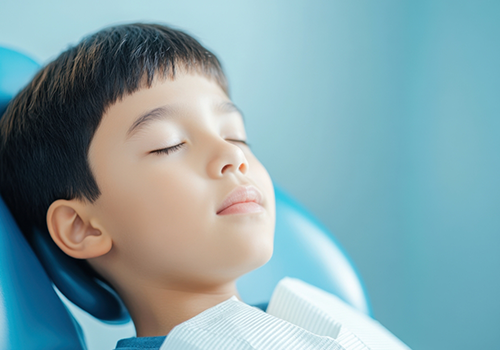 Boy relaxing in the dental chair with his eyes closed