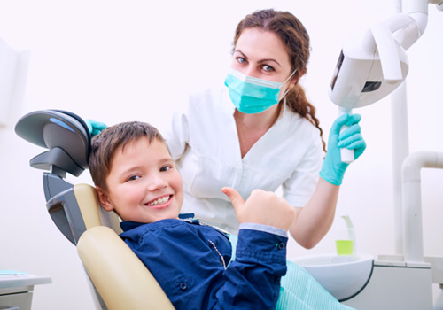 Child smiling in preparation for general anesthesia