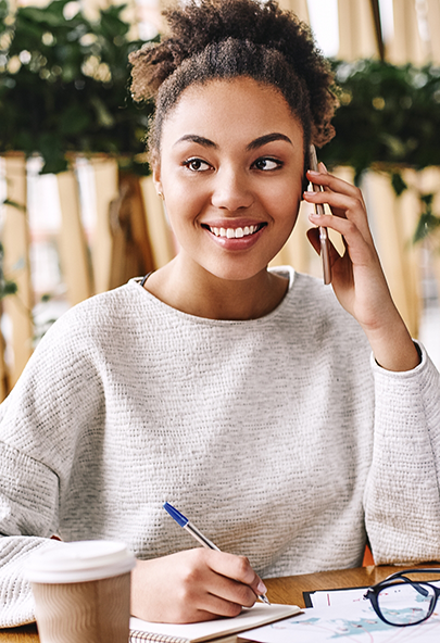 Woman smiling while talking on the phone with a pediatric dental office in Bakersfield