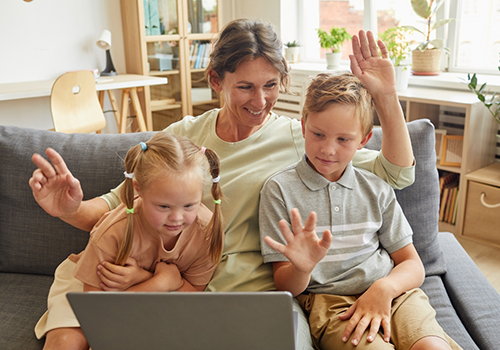 Mother and two children on a video call on a laptop