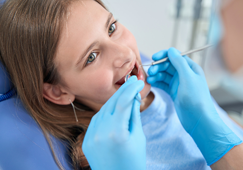 Teenager receiving a dental exam