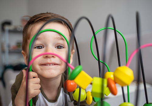 Toddler smiling with their teeth at home