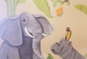 Wall art of an elephant and a hippo with a bird perched on its head