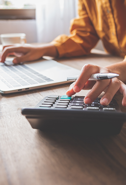 Person typing on a calculator