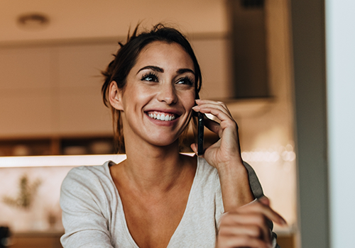 Woman smiling while talking on the phone
