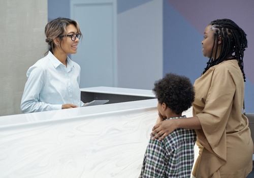 Mother and son with a receptionist