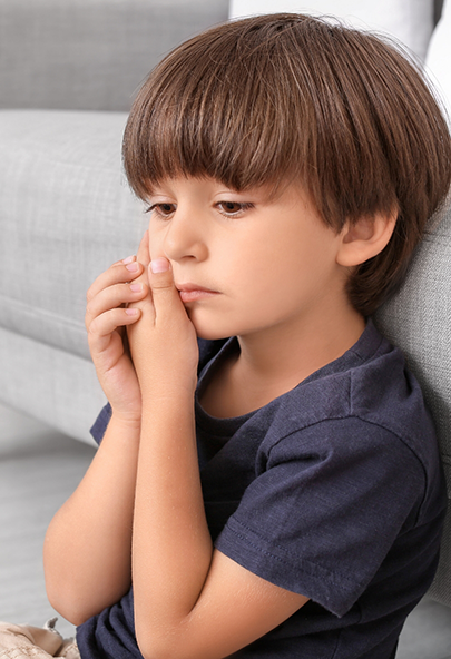 Young boy holding the side of his face in pain