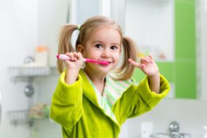 Kid brushing their teeth.