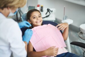 Young girl smiling at the dentist