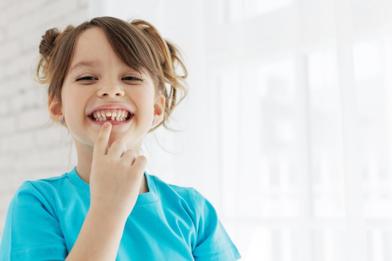 Child smiling after tooth extraction